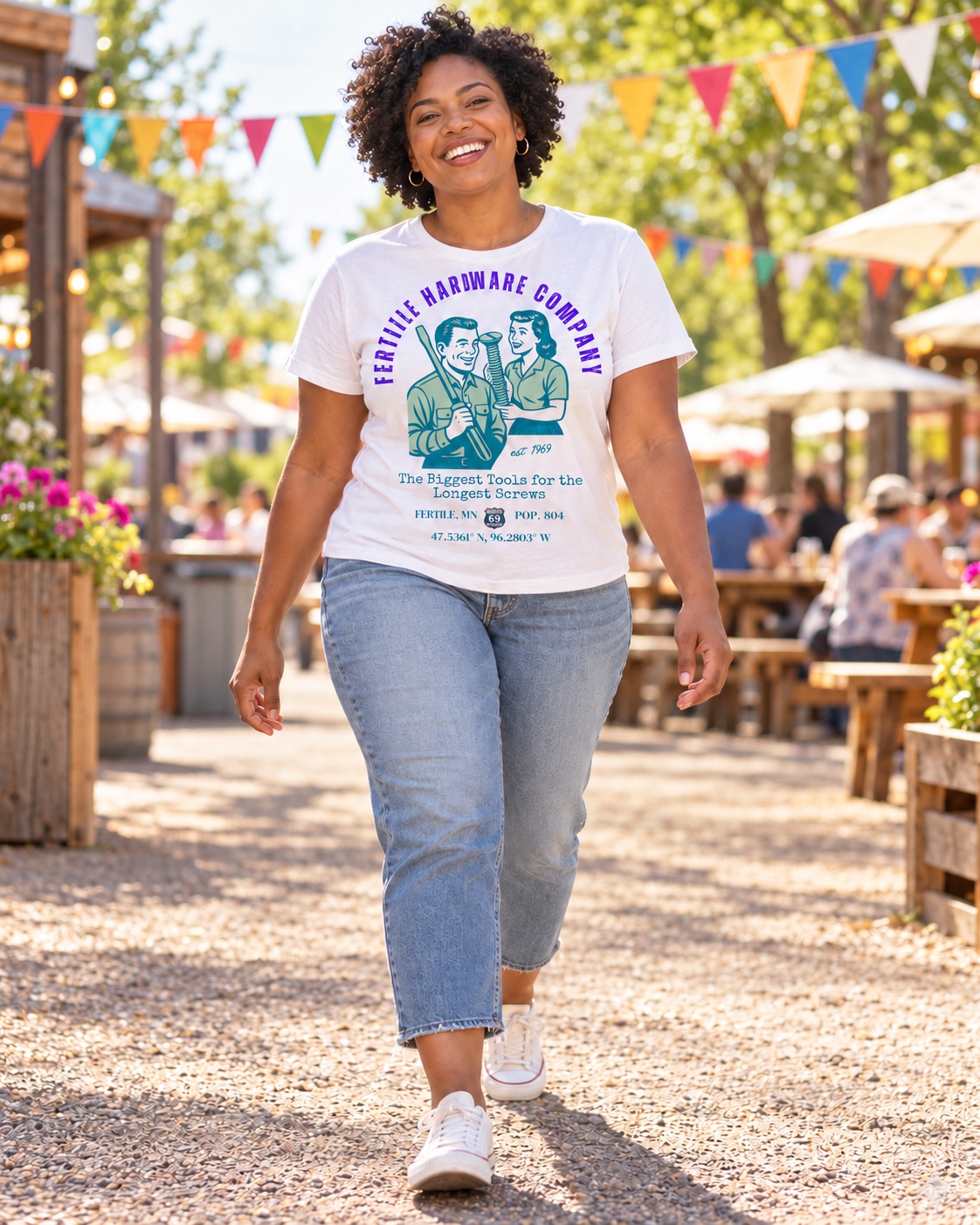 Model wearing the white Fertile Hardware Company tee at a roadside gathering